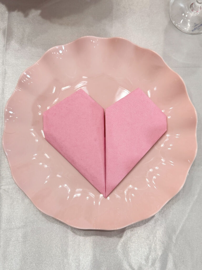 Valentines themed table decor with heart shaped napkins and reusable plastic plates